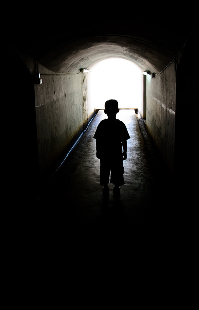 young boy in long tunnel walkway - Photo, Image