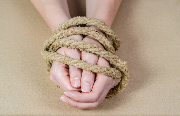 Woman's hands tied with a rope .Concept regarding sexual slavery . - Fotoğraf, Görsel
