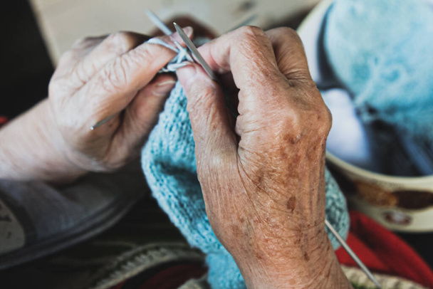Grandmother knits woolen socks, her hands closeup - Foto, Imagen