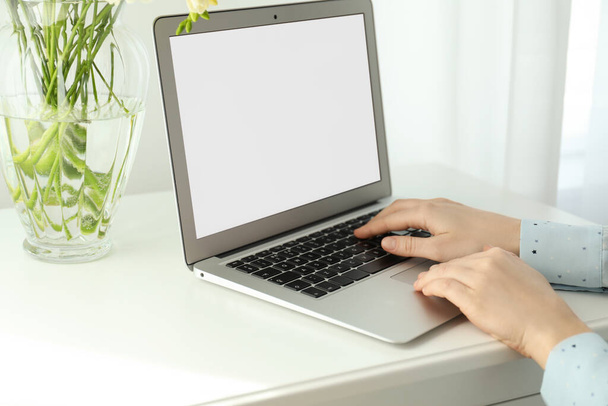 Woman working on modern laptop at white table indoors, closeup - Фото, зображення