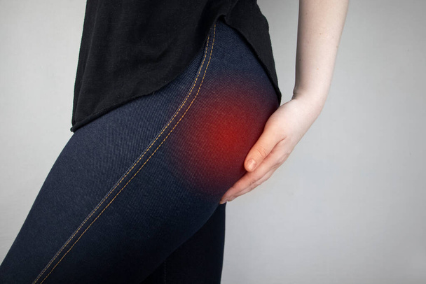 A woman suffers from pain in the buttock. The doctor diagnoses the patient piriformis syndrome, pinch of the sciatic nerve, lumbar osteochondrosis or sciatica - Photo, Image
