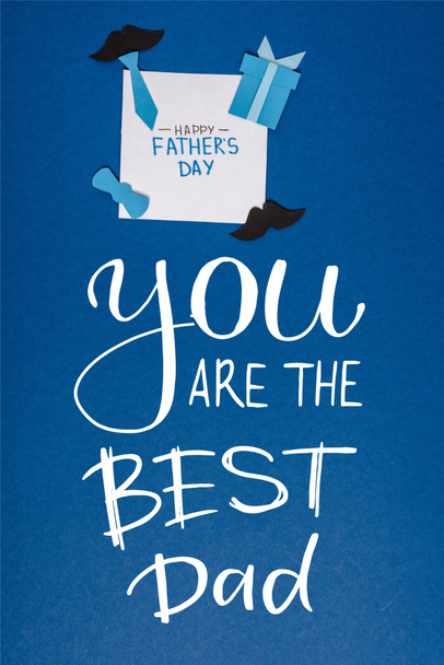 top view of greeting card with lettering happy fathers day and paper craft creative decorating elements on blue background, you are the best dad illustration - Photo, Image