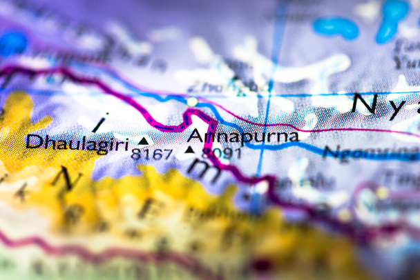 Shallow depth of field focus on geographical map location of Mount Annapurna Dhaulagiri in Nepal in Asia continent on atlas - Photo, Image
