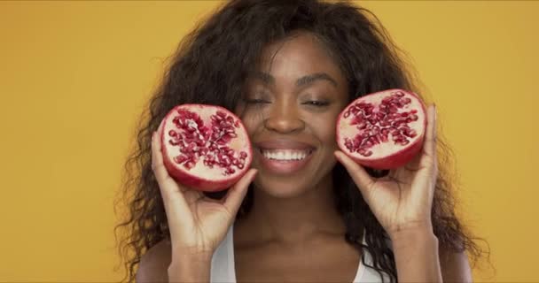 Pleased black woman with pomegranate - Video, Çekim