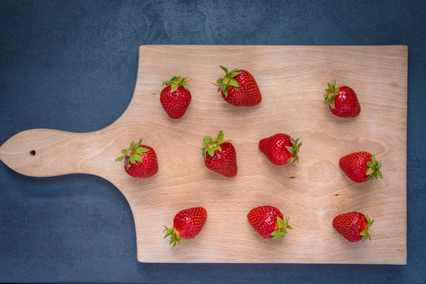 Fresh ripe delicious strawberries on wooden board. - 写真・画像