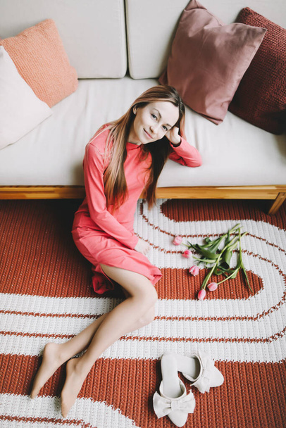 Romantic portrait of a girl in pink dress indoors. Beautiful young woman - Foto, imagen