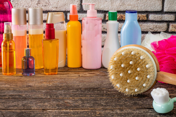 Many kinds of shampoo and shower gel bottles and sponge on the table - Photo, Image