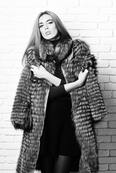 fashionable sexy woman in fur on brick wall studio background - Photo, Image