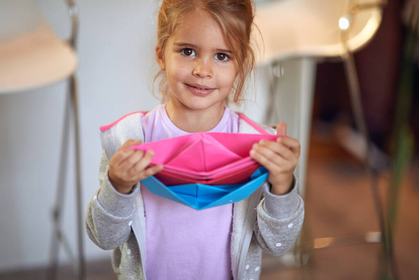 cute little girl  playing with paper boats. - Zdjęcie, obraz