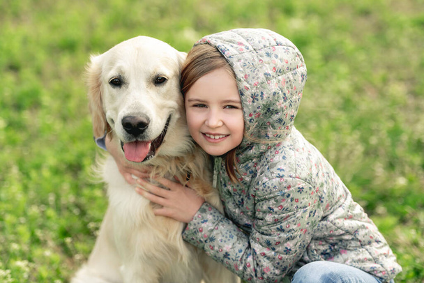 Pretty little girl embracing cute dog - Фото, зображення