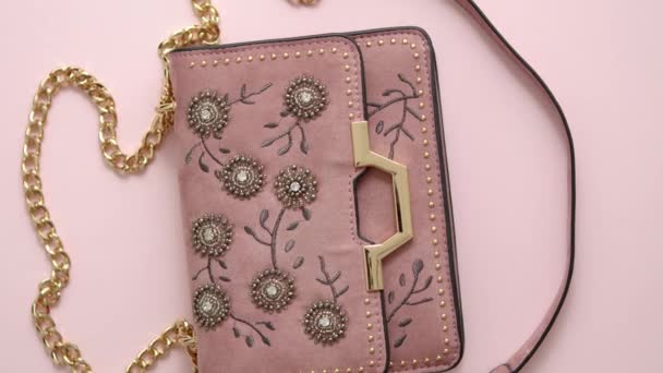 Ünnepi esti női táska elszigetelt rózsaszín háttérrel. Luxus női kiegészítők és party koncepció - Felvétel, videó