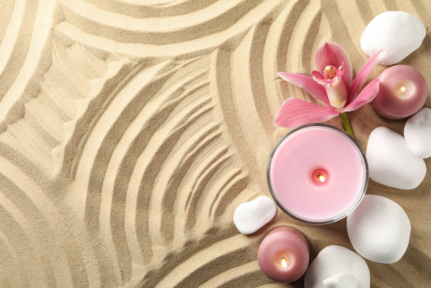 Candles and stones on sand background, top view. Zen concept - Photo, Image