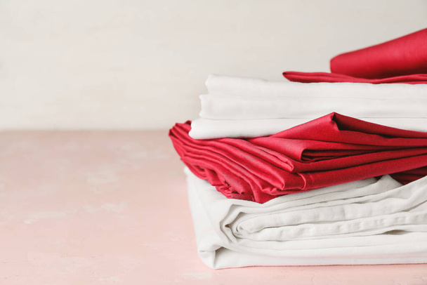 Stack of clean bed sheets on table - Φωτογραφία, εικόνα