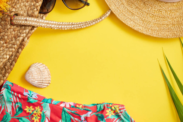 Female beach summer clothes and accessories collage on yellow background - Photo, Image