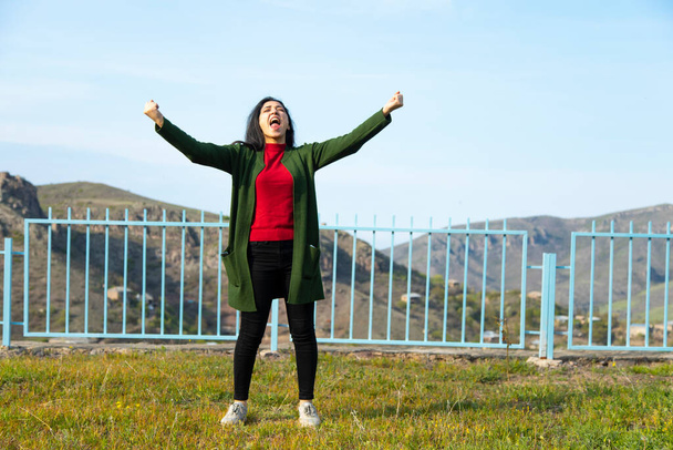 happy woman in mountain under sky background - Fotoğraf, Görsel