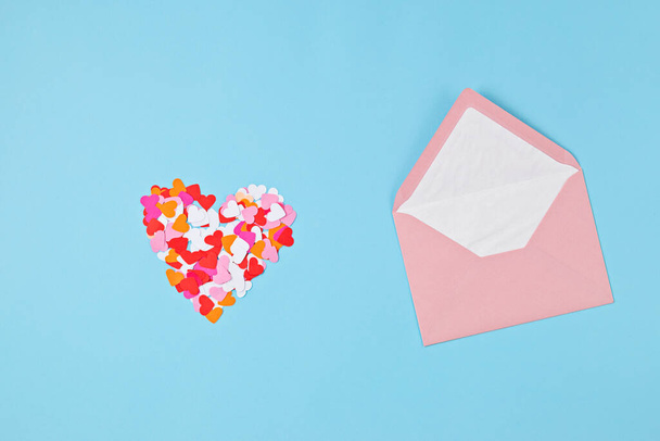 Hearts confetti and pink envelope. Love, valentine day, mothers day greeting card, gratitude, expressing gratitude to doctors and nurses concept - Fotó, kép