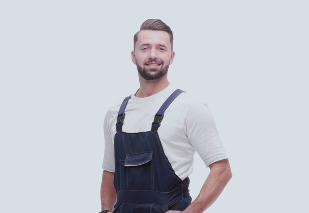 side view. smiling man in overalls looking forward to copy space - Foto, Bild