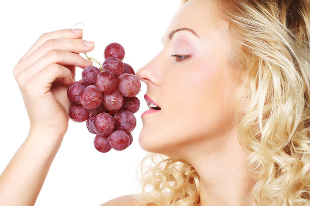 Young woman holding bunch of grapes - Φωτογραφία, εικόνα