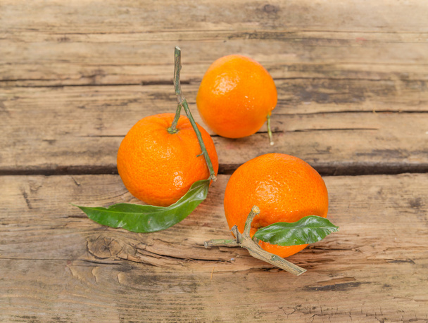 Tangerine fruits on wooden background - Φωτογραφία, εικόνα