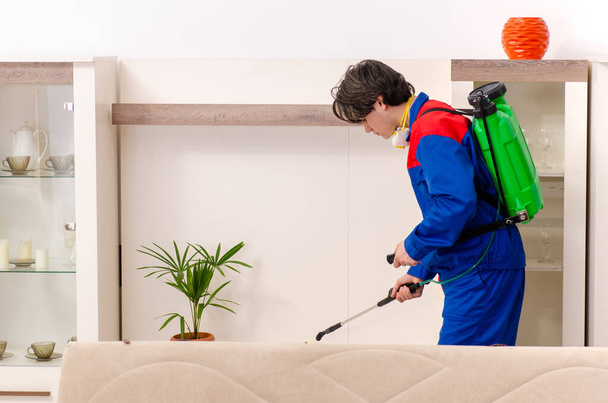 Young contractor doing pest control at home - Photo, Image