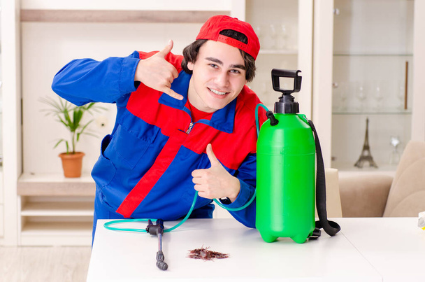 Young contractor doing pest control at home - Photo, Image
