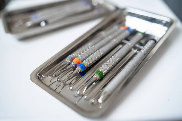 Dentist tools in metal tray on table close up. Teethcare, dental health concept. Light background top view copy space flat lay. Teeth care fresh breath. Horizontal - Фото, изображение