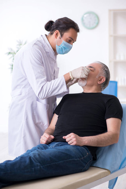 Old man visiting young doctor for plastic surgery - Photo, Image