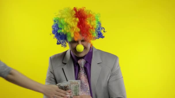 Clown businessman entrepreneur counts money income. Hand steals cash from man - Footage, Video