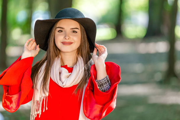 Portrait of a beautiful fashionable girl outdoor on sunny spring day, breating fresh air in park. - Fotó, kép