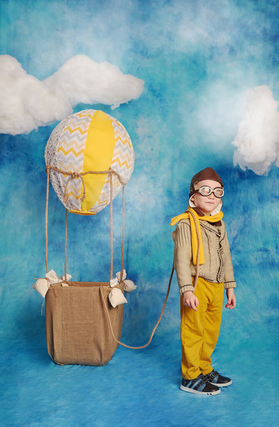 Dreams of travel! Funny child flying on balloons - Fotó, kép