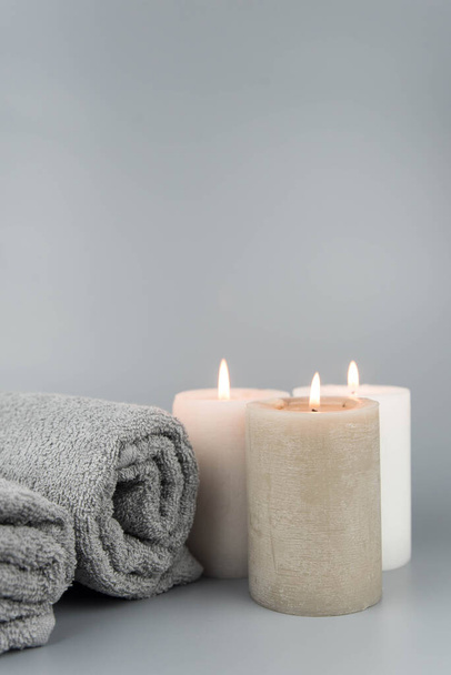 Towel with aromatic candles. Aromatherapy and beauty. Concept set of harmony, massage, balance and meditation, spa, relax, beauty spa treatment. - Photo, image