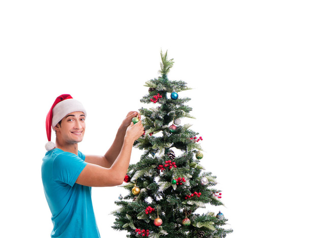 Young man decorating christmas tree isolated on white - Foto, Imagem