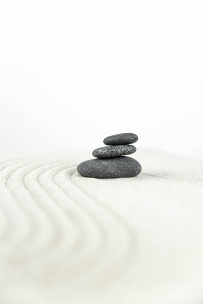 Jardín Zen. Pirámides de piedras zen blancas y grises sobre la arena blanca con dibujos de ondas abstractas. Concepto de armonía, equilibrio y meditación, spa, masaje, relax
. - Foto, imagen