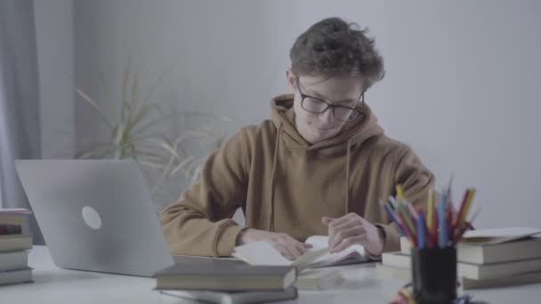 Front view of nervous stressed teenager throwing crumpled paper to camera. Portrait of Caucasian boy tired from studying. Overworking, education, lifestyle, adolescence. - Záběry, video