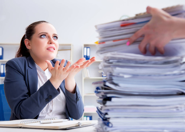 Tired businesswoman with paperwork workload - Photo, Image