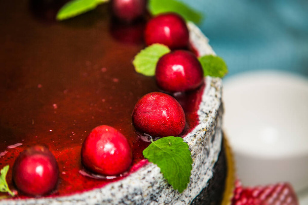 Delicious sweet poppy cake with different fresh cherry. Sweet homemade cake. Closeup - Foto, Imagem