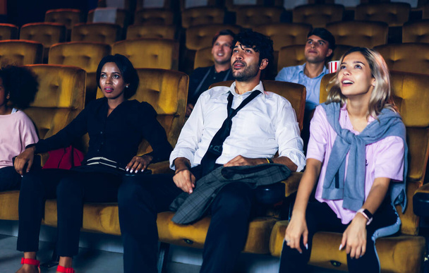 Зрители счастливы и увлекательны в кинотеатре. Концепция группового отдыха и развлечений. - Фото, изображение