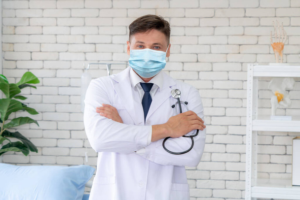 Doctor wear face mask in hospital protect from coronavirus disease or COVID-19. Medical staff are high risk people to receive infection from coronavirus disease or COVID-19. - Photo, Image