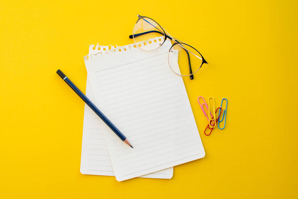empty notebook on yellow background with school concept. - Foto, Imagem