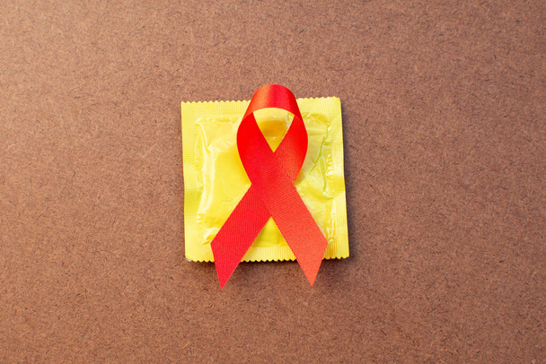 Fita vermelha e preservativo Conceito de dia Mundial da Aids
.  - Foto, Imagem