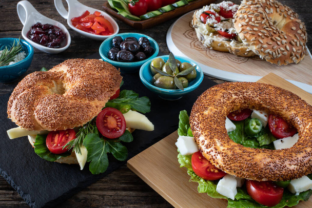 A fresh bagel burger stuffed for breakfast. Simit concept with many appetizer.  - Photo, image