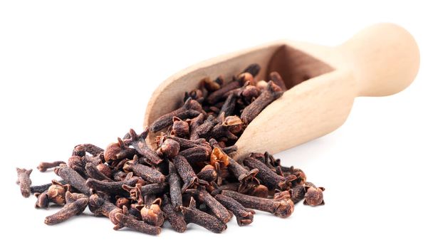 Spice clove in a wooden scoop close-up on a white background. Isolated - Photo, Image