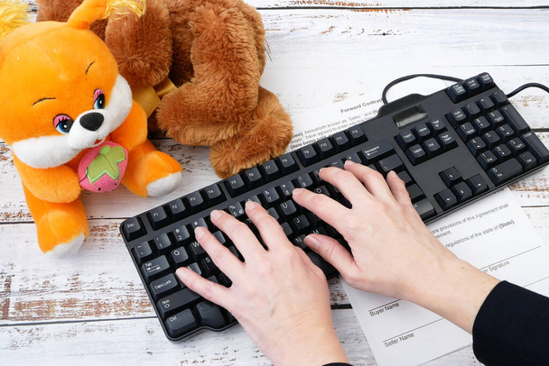 remote work concept, a business woman removes children's plush toys from the table, puts business papers and pen and starts working - Photo, Image