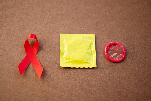 Red ribbon and condom World Aids day concept.  - Fotoğraf, Görsel