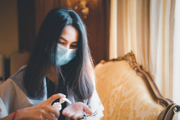 Asian woman wearing mask and alcohol antibacterial hand gel respiratory protection mask against epidemic flu covid19 or corona virus with fear emotion in concept illness, outbreak, healthcare in life - Fotó, kép