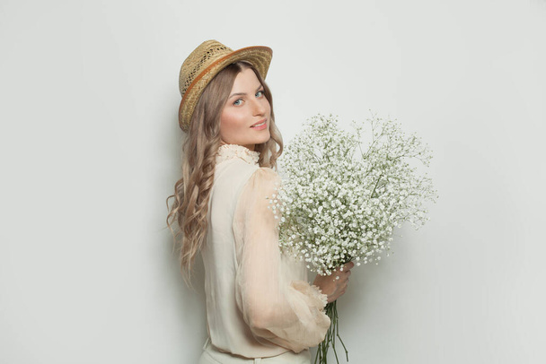 Beautiful woman with flowers on white background - Фото, зображення