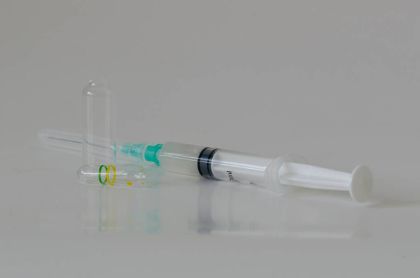 Ampoul, syringe  with needles on white table. - Photo, Image