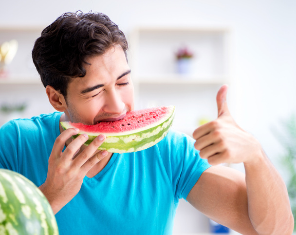 Man eating watermelon at home - Photo, Image