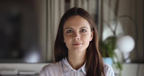 Cheerful young adult businesswoman, student or intern looking at camera - Materiał filmowy, wideo