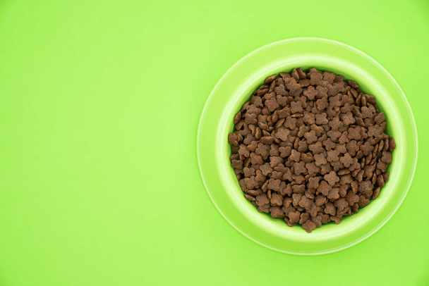 dog food in a bowl on the green background - Photo, image